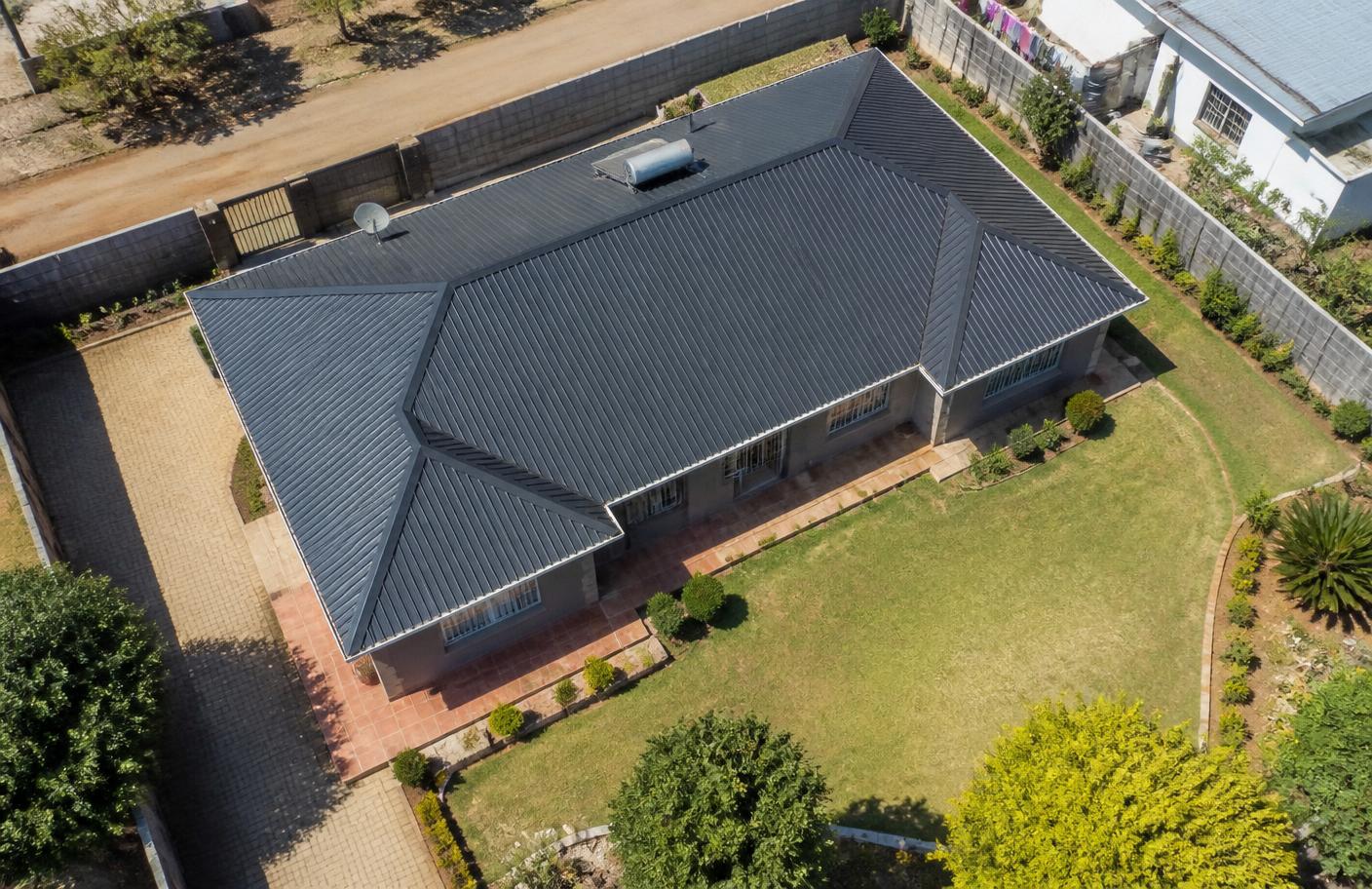 Elevated view of a Harare home's IBR roof during an inspection