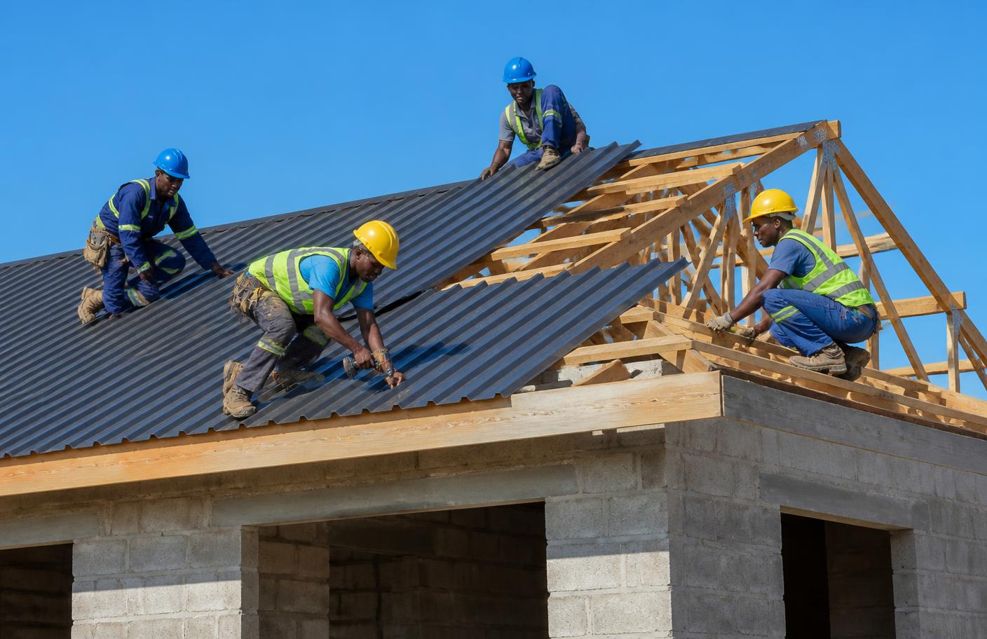 Roofing crew installing IBR sheets on a new home in Zimbabwe